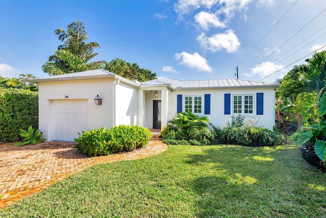 single story home with a front yard and a garage