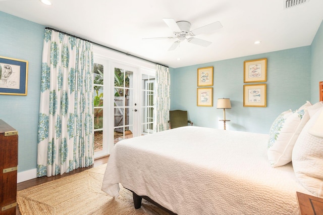 bedroom featuring access to exterior, hardwood / wood-style floors, and ceiling fan