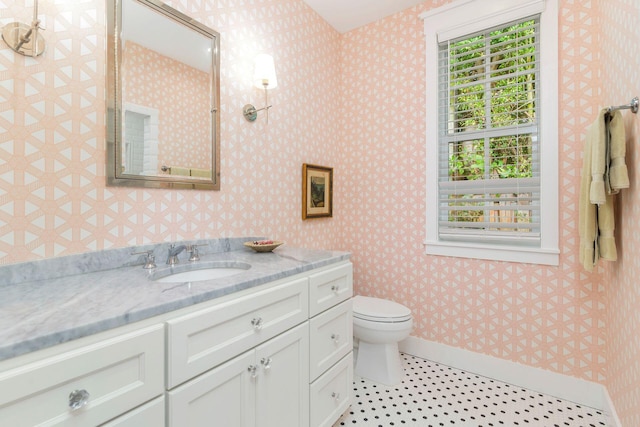 bathroom with plenty of natural light, vanity, and toilet