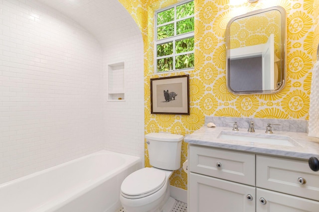 bathroom featuring a washtub, vanity, and toilet