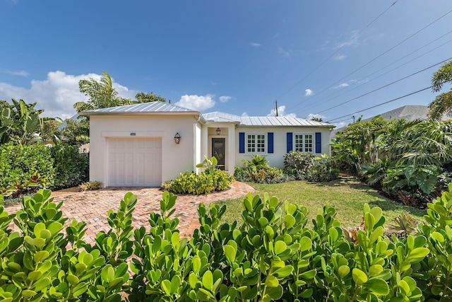 view of front facade with a front lawn and a garage