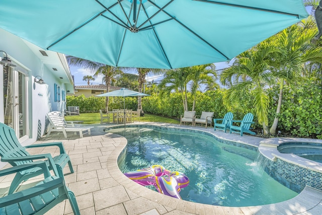 view of swimming pool with a patio area, an in ground hot tub, and pool water feature