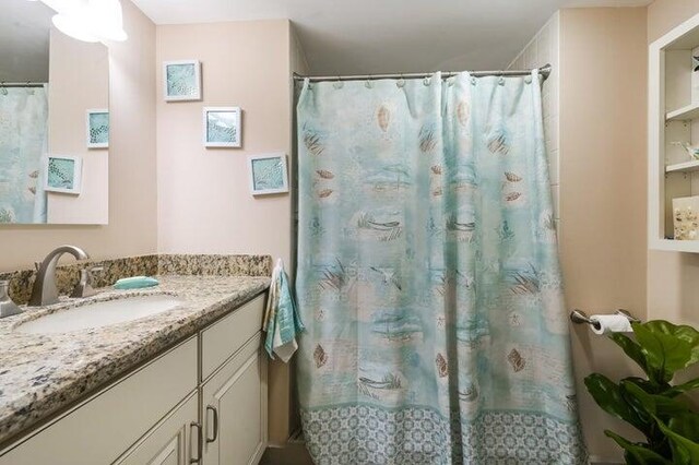 bathroom with a shower with curtain and vanity