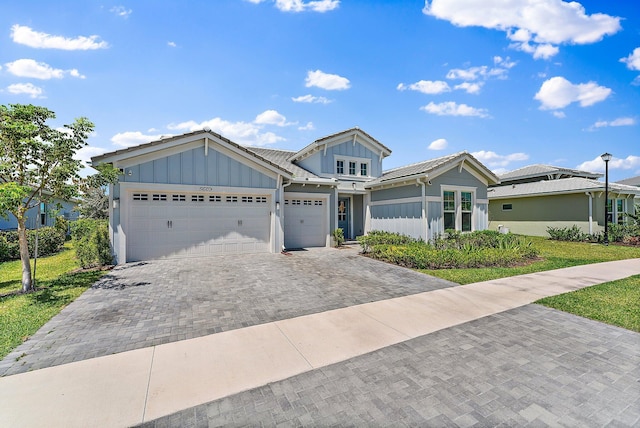 view of front of property with a front lawn and a garage