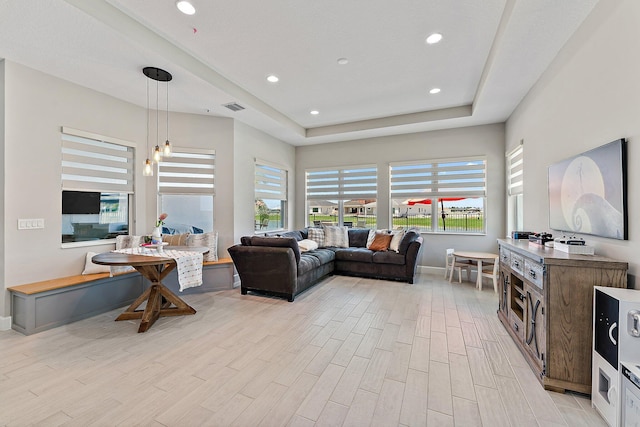 living room featuring breakfast area and light wood-type flooring