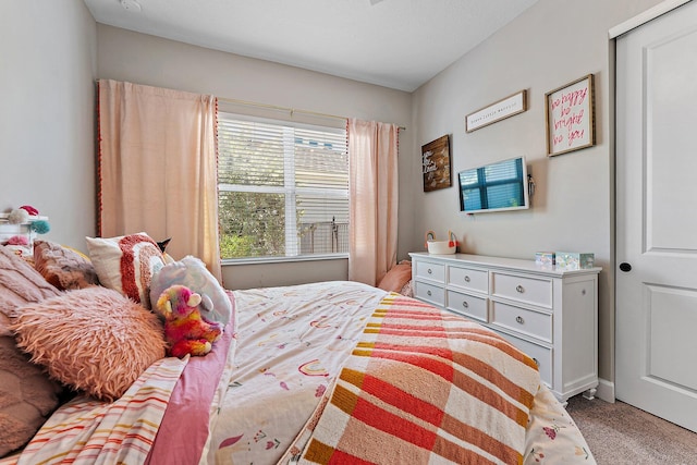 carpeted bedroom with a closet