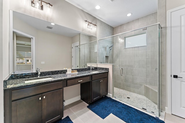 bathroom with tile patterned floors, vanity, and an enclosed shower