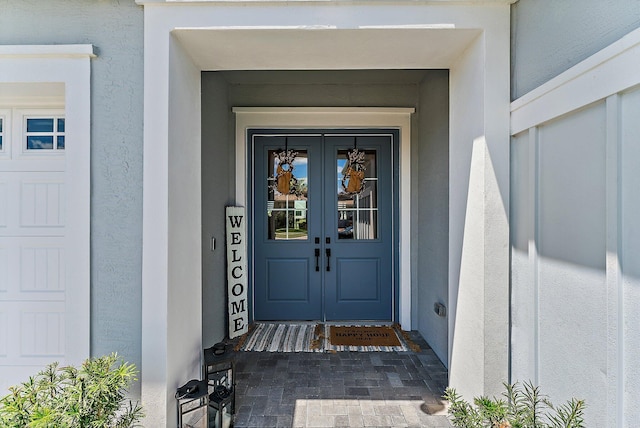 view of exterior entry featuring french doors