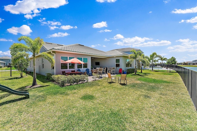 rear view of house featuring a lawn