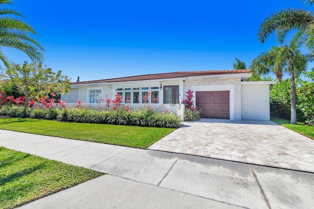 view of front of house with a front yard and a garage