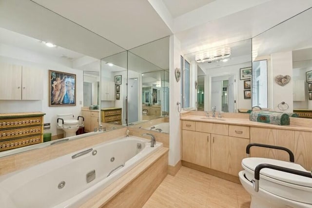 bathroom featuring tile patterned floors, vanity, a relaxing tiled tub, and toilet