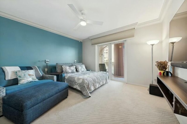 carpeted bedroom featuring ceiling fan and crown molding