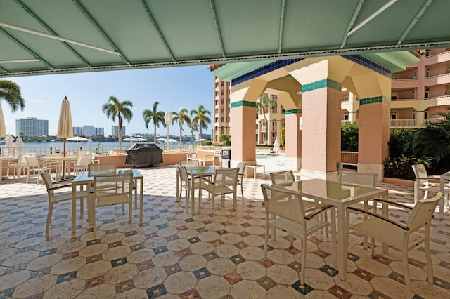 view of patio / terrace featuring area for grilling and a water view