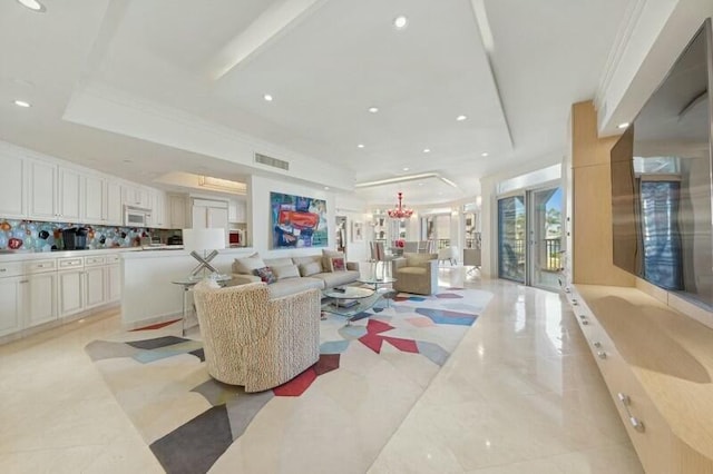 living room featuring a tray ceiling and crown molding