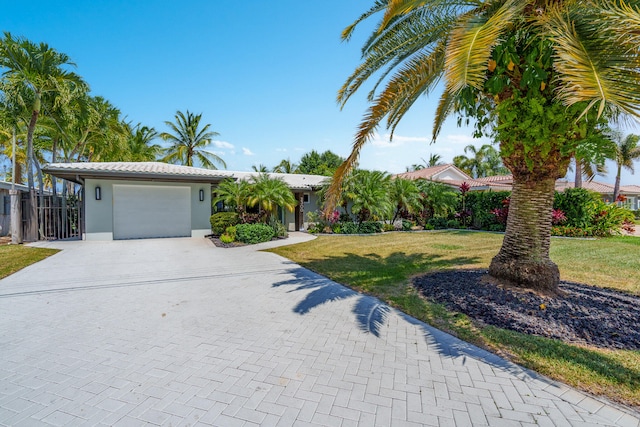 view of front facade with a garage and a front yard