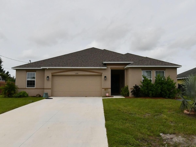 view of front of property featuring a front lawn and a garage