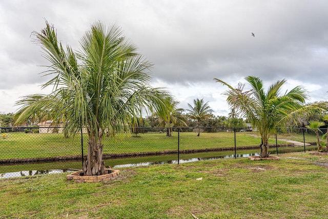 view of home's community featuring a yard and a water view