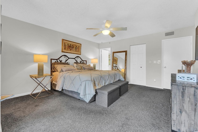 bedroom featuring dark colored carpet, ceiling fan, a textured ceiling, and a closet