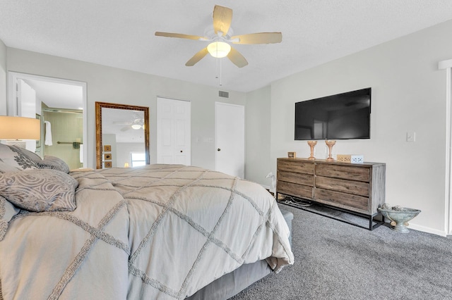 carpeted bedroom featuring a textured ceiling, a closet, ensuite bathroom, and ceiling fan