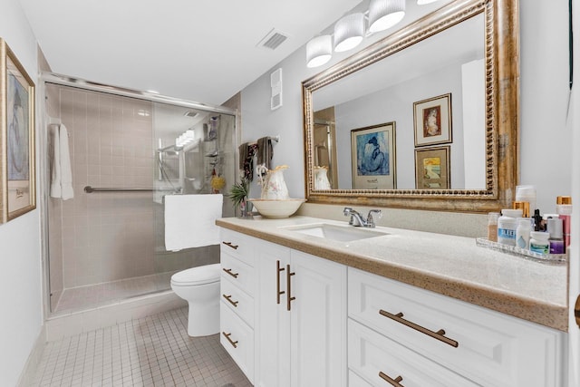 bathroom with tile patterned floors, a shower with door, vanity, and toilet