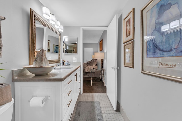 bathroom featuring tile patterned flooring, vanity, and toilet