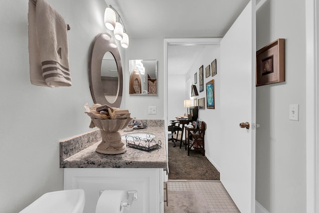 bathroom with tile patterned flooring and vanity