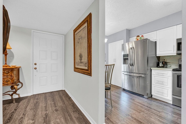 interior space with a textured ceiling and dark wood-type flooring