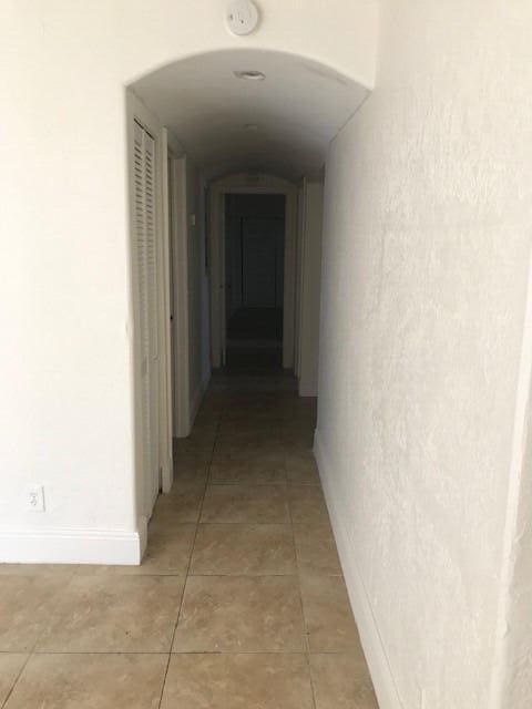 hall featuring tile patterned flooring