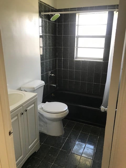 full bathroom featuring vanity, toilet, and tiled shower / bath