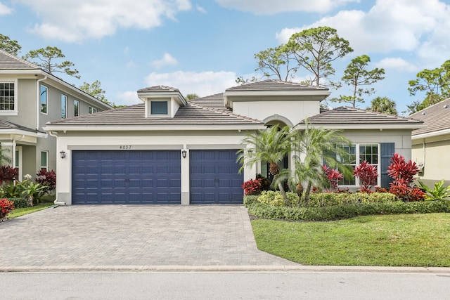 view of front of house with a front yard and a garage