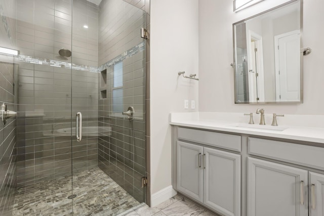 bathroom featuring vanity and an enclosed shower