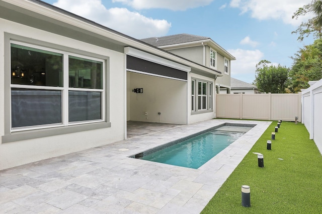 view of swimming pool with a yard and a patio area