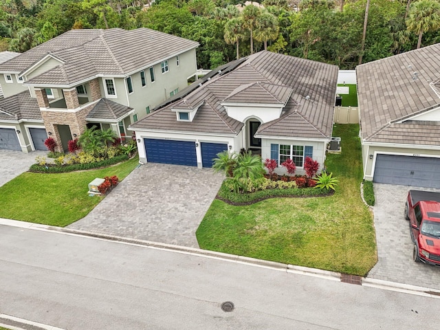 view of front of property with a garage and a front lawn