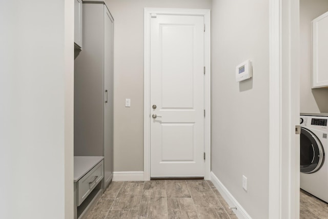 washroom with cabinets, washer / dryer, and light hardwood / wood-style flooring