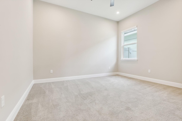 unfurnished room with ceiling fan and light colored carpet