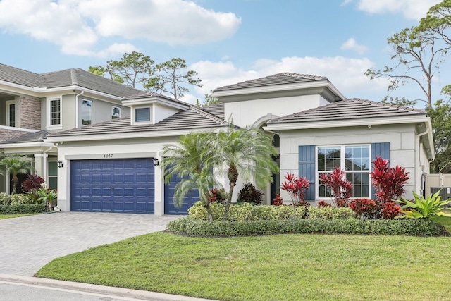 view of property featuring a garage and a front yard