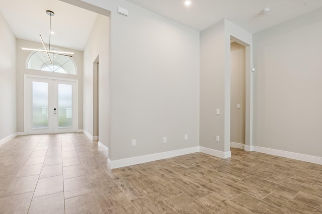 foyer with french doors and light hardwood / wood-style floors