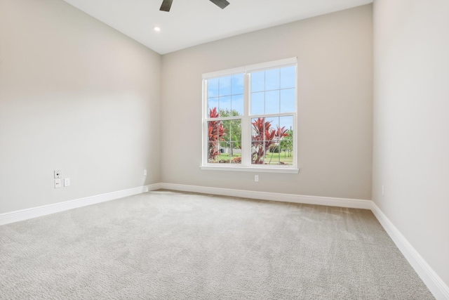 carpeted empty room featuring ceiling fan