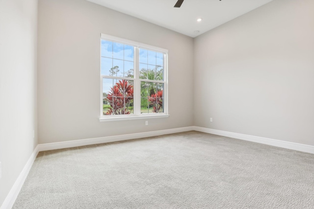 carpeted empty room with ceiling fan and a healthy amount of sunlight