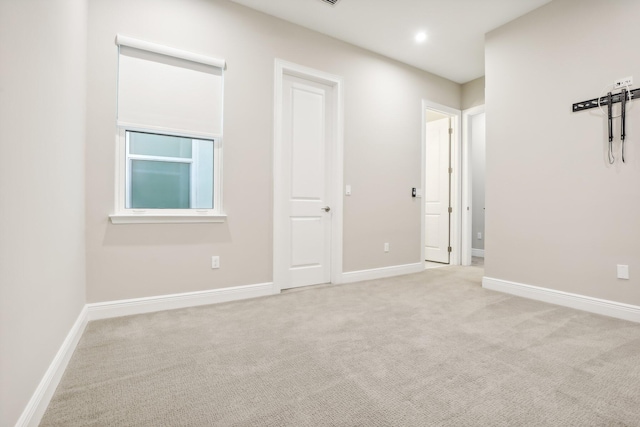 spare room with light carpet