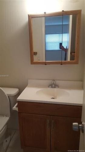 bathroom with vanity and toilet