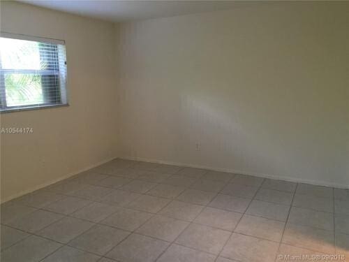 unfurnished room with light tile patterned floors