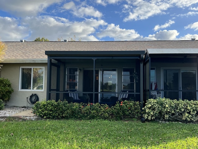 rear view of property with a lawn