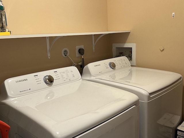 clothes washing area with washer and dryer