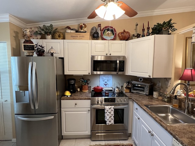 kitchen featuring light tile patterned flooring, sink, white cabinets, and stainless steel appliances