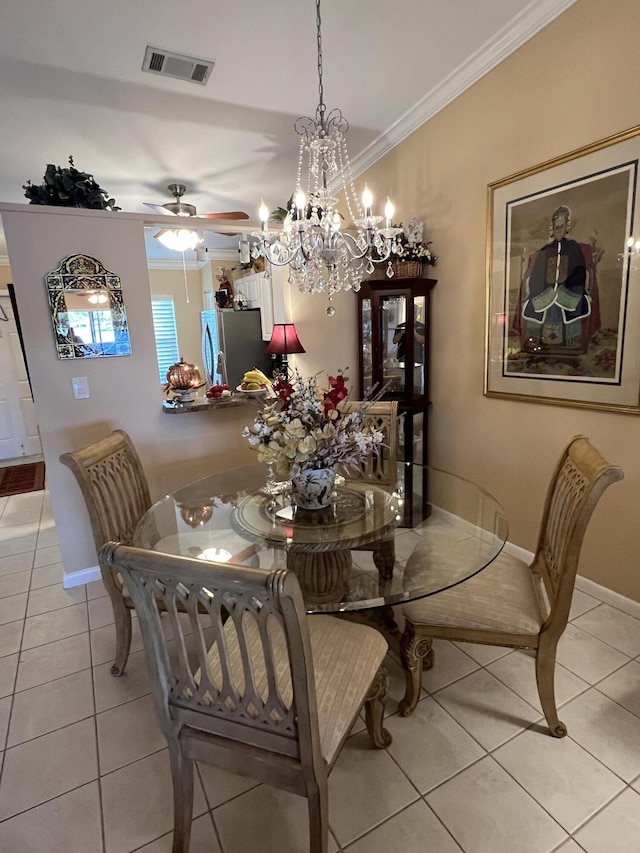 tiled dining area with ceiling fan with notable chandelier and crown molding