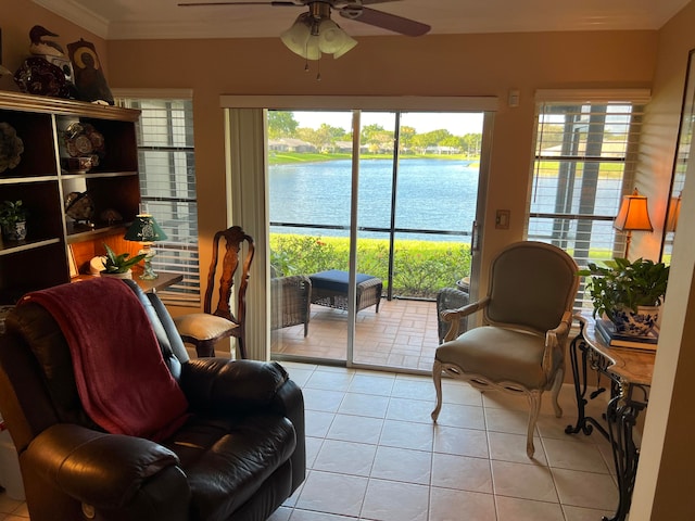 sunroom featuring a water view and ceiling fan