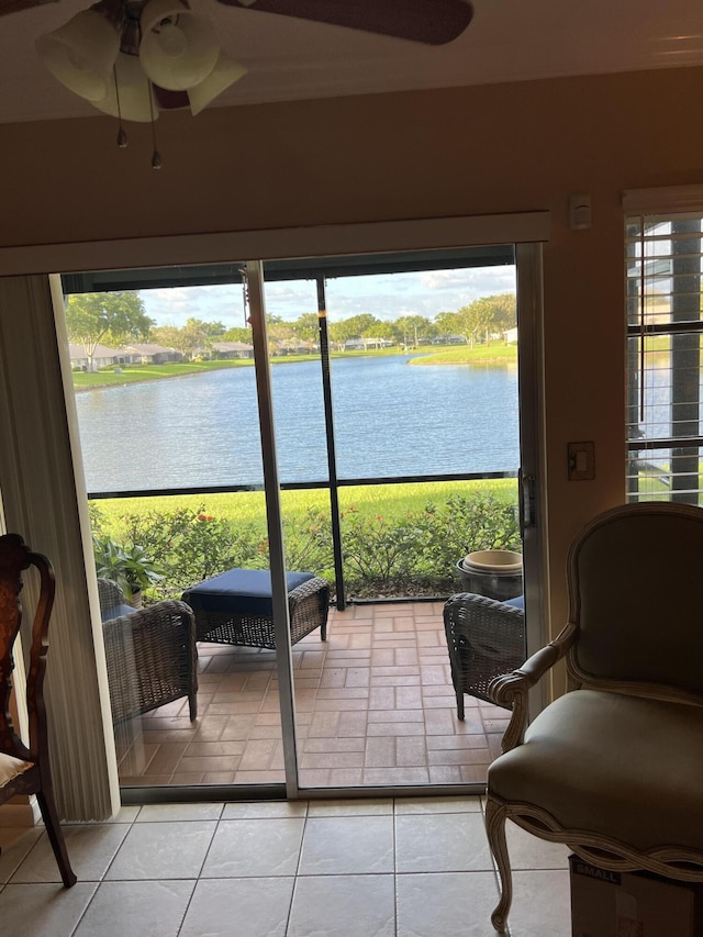 sunroom / solarium featuring a water view