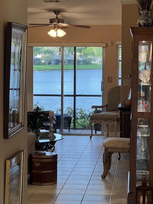 sunroom with heating unit, a water view, and ceiling fan