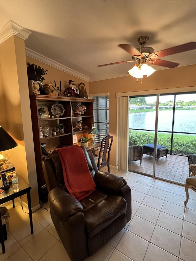 living area featuring ceiling fan, a water view, light tile patterned floors, and ornamental molding